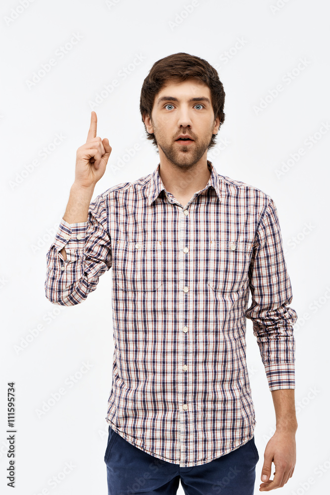 Portrait of handsome thinking man, looking at camera, pointing u Portrait of handsome thinking man, looking at camera, pointing u