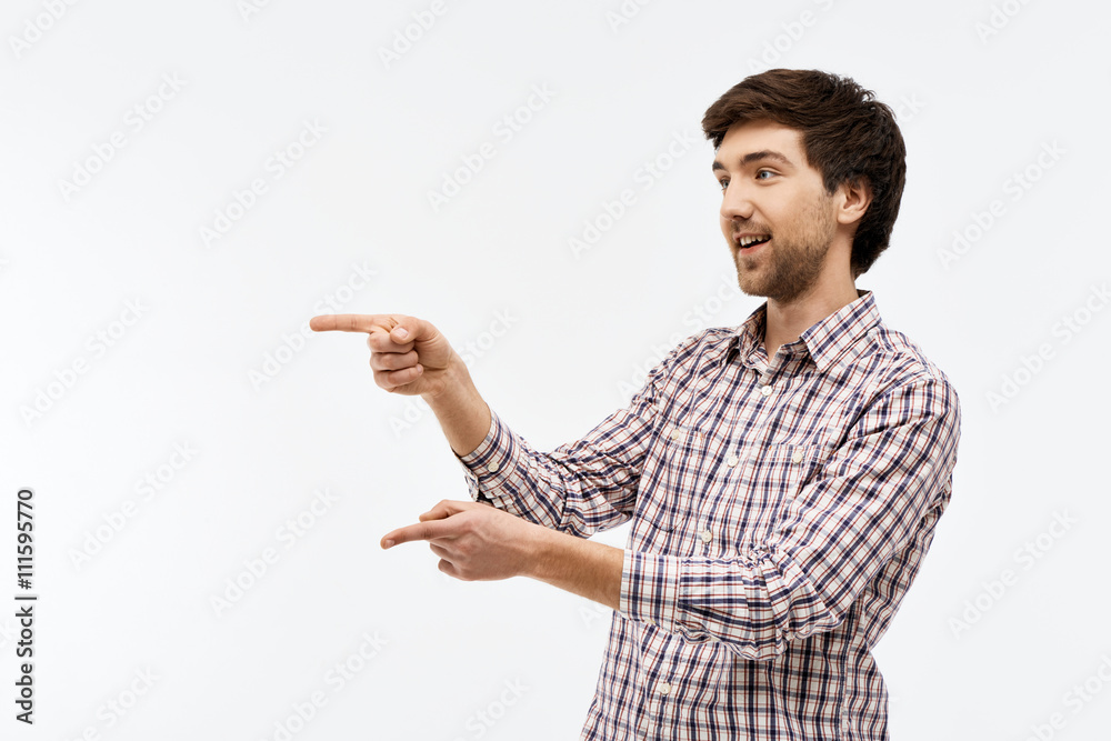 Portrait of handsome confident young man, looking away, pointing Portrait of handsome confident young man, looking away, pointing