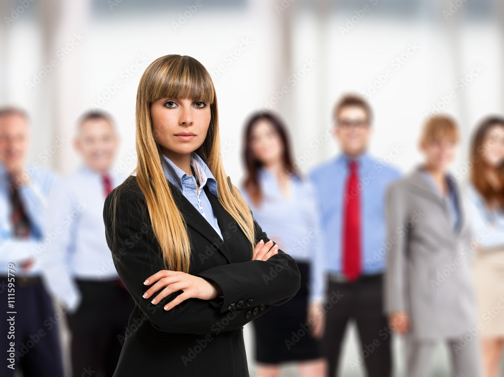 Woman in front of a group of business people Woman in front of a group of business people