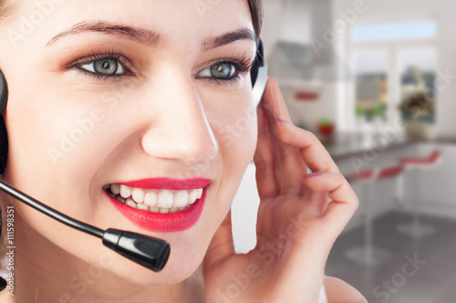 Closeup of beautiful young smiling woman with headset