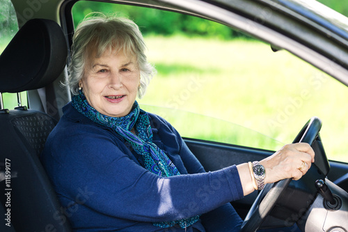 active senior lady with her car in country outdoor