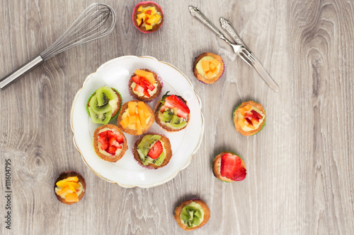 top view of mini pastry with custard cream and fresh fruits photo