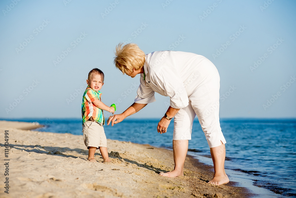 Happy baby with his grandmother in the summer Happy baby with his grandmother in the summer