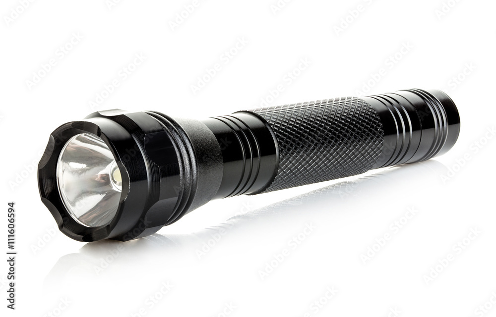 Black metallic flashlight close-up isolated on a white background.