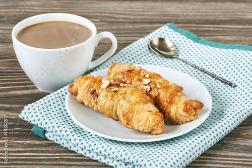 Coffee with milk and croissant