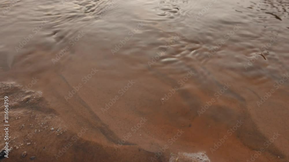 Water flowing through a cold sand, closeup. 4K UHD. Water flowing through a cold sand, closeup. 4K UHD.