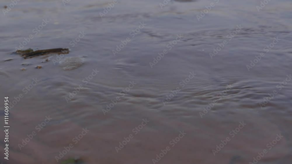 Water flowing through a cold sand, closeup. 4K UHD. Water flowing through a cold sand, closeup. 4K UHD.