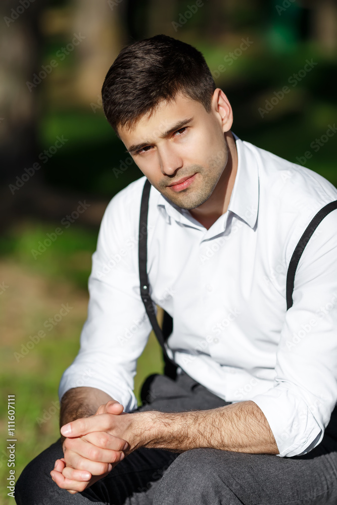 Young beautiful groom sitting on a chair Young beautiful groom sitting on a chair