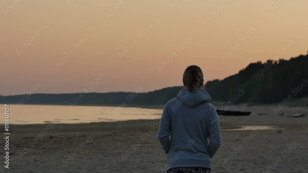 Dreamy young woman enjoying sun on the beach. Northern baltic seascape. 4K UHD. Dreamy young woman enjoying sun on the beach. Northern baltic seascape. 4K UHD.