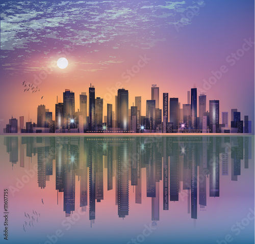Modern night city landscape in moonlight or sunset, with reflection in water and cloudy sky © dahabians