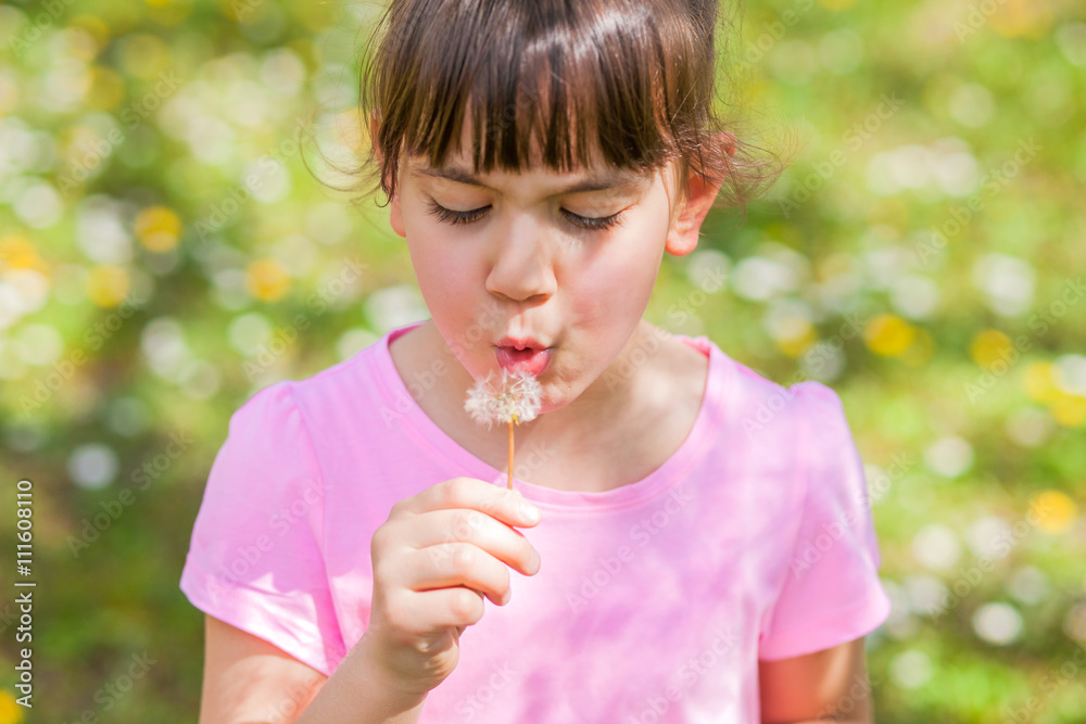 Child blowing dandelion Child blowing dandelion