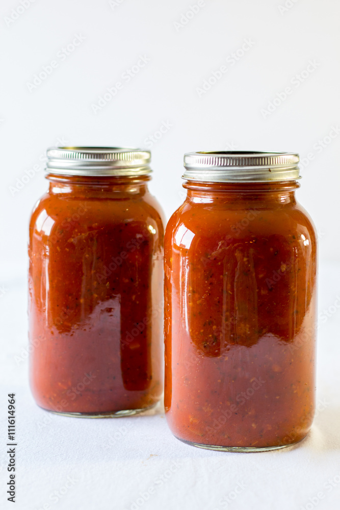spaghetti sauce in a jar on a white background spaghetti sauce in a jar on a white background