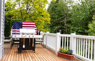 Home outdoor patio with BBQ cooker preparing for holiday picnic