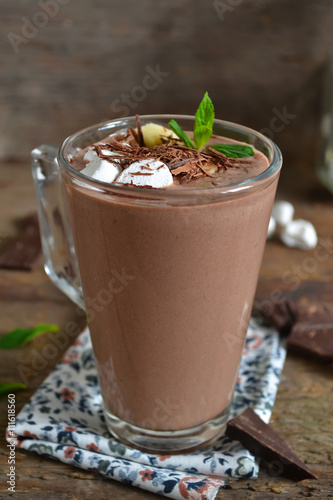 chocolate smoothie with oats and marshmallow on a wooden backgro