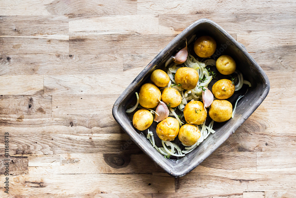 cooking small whole yellow potatoes with peel in an old porcelain plate