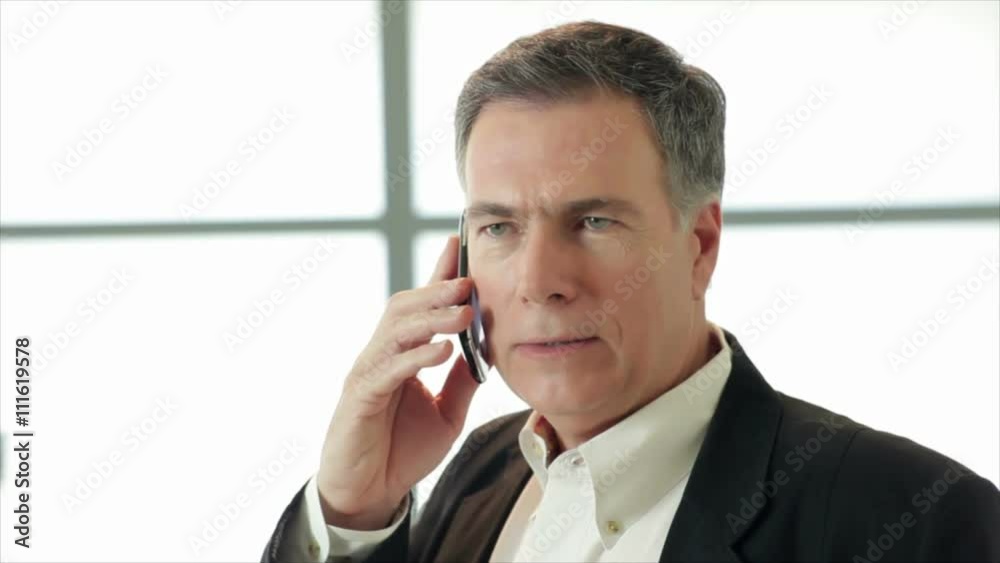 Weary fatigued business man talking on his cell phone. Weary fatigued business man talking on his cell phone.