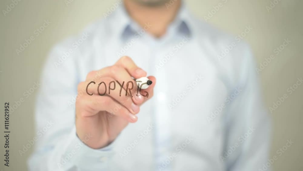 Copyright Law, man writing on transparent screen Copyright Law, man writing on transparent screen