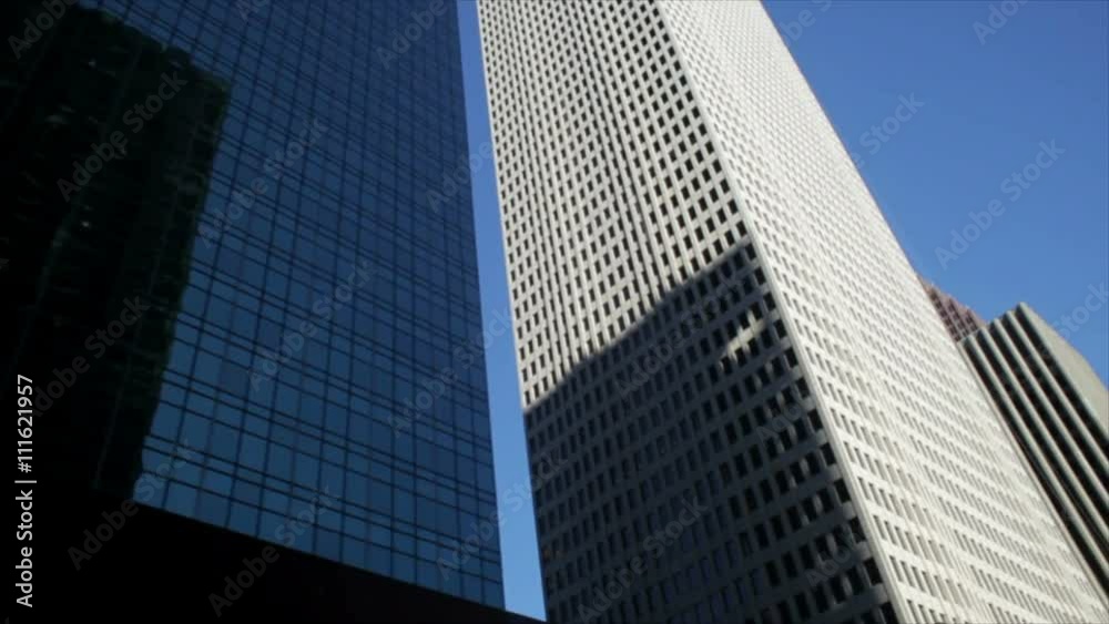 Driving past the tall and sometimes reflective exteriors of the professional office buildings in downtown Houston Texas Driving past the tall and sometimes reflective exteriors of the professional office buildings in downtown Houston Texas