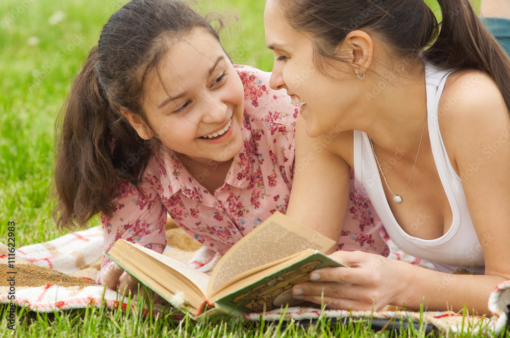 two girls lying on the plaid and laughing two girls lying on the plaid and laughing