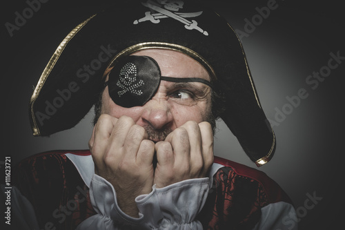 Fototapeta Fear pirate with eye patch and old hat with funny faces and expr