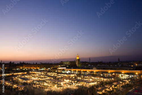 Fototapeta Naklejka Na Ścianę i Meble -  Morocco. Marrakech. The Jemaa el-Fna Square at sunset. Blurred motion in the foreground