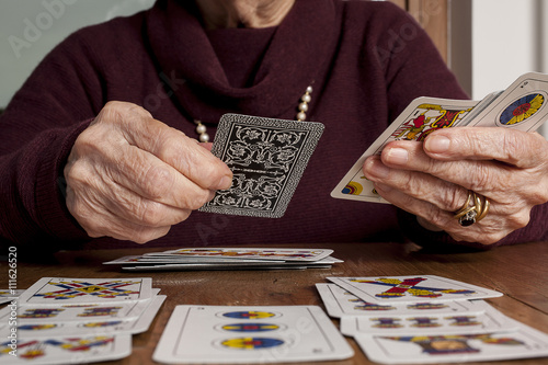 senior woman playing solitaire photo