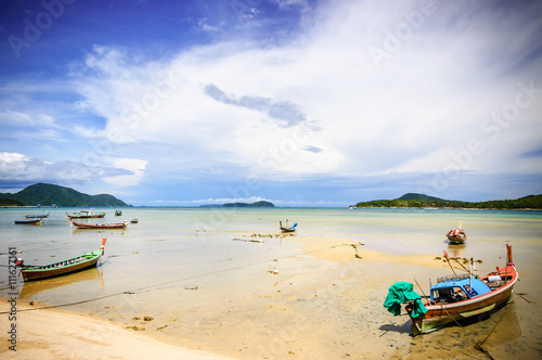 Long-tail boats on Rawai beach at low tide, Phuket, Thailand