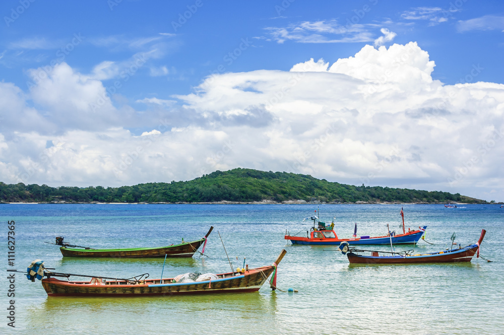 Long-tail boats at anchor at high tide, Phuket, Thailand
