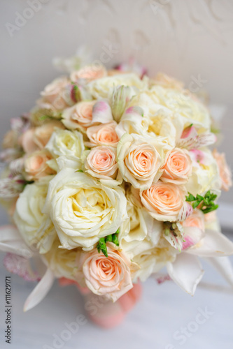 Beauty of colored flowers. Bridal accessories. Close-up bunch of florets. Details for marriage and for married couple. Wedding bouquet with tender orchids  roses on the white background