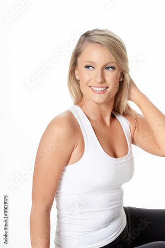 Studio shot of beautiful blonde model in gym outfit, isolated on white