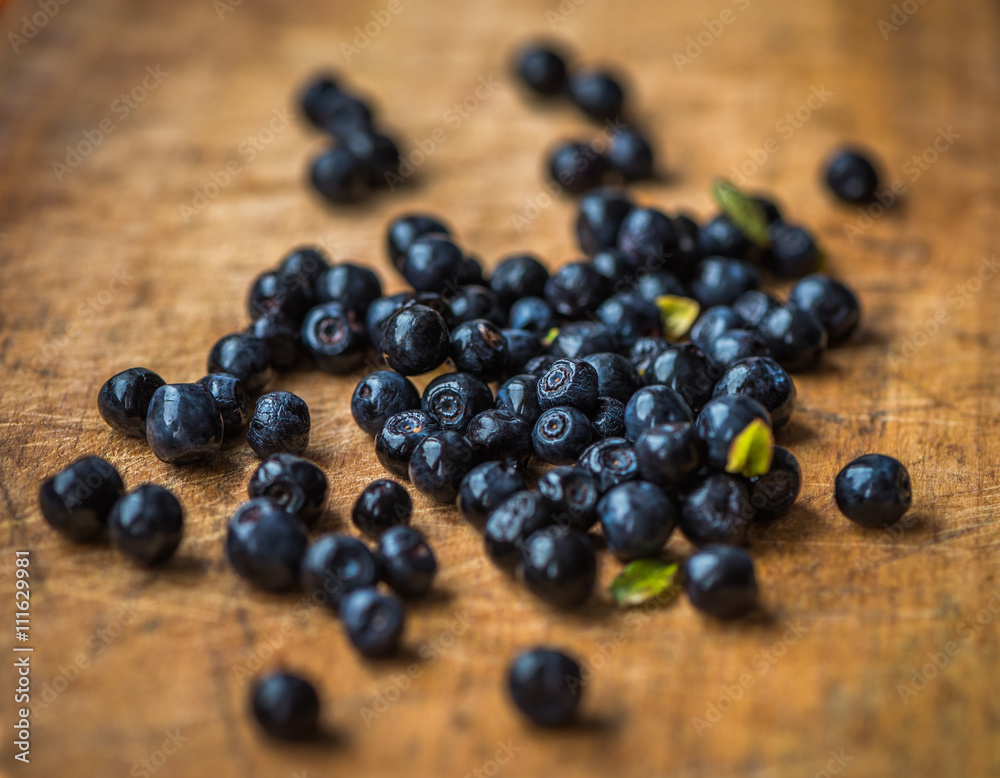 Fresh Blueberries Picked in the Forest on Wooden Background Fresh Blueberries Picked in the Forest on Wooden Background