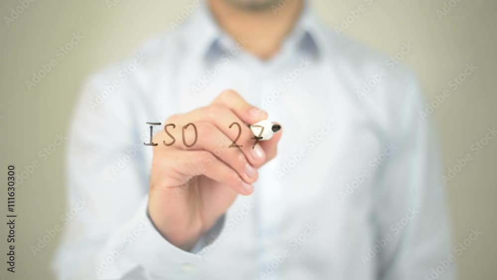 ISO 27001 , man writing on transparent screen ISO 27001 , man writing on transparent screen