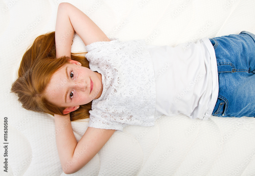 Young girl is lying on the bed. Quality mattress. Young girl is lying on the bed. Quality mattress.