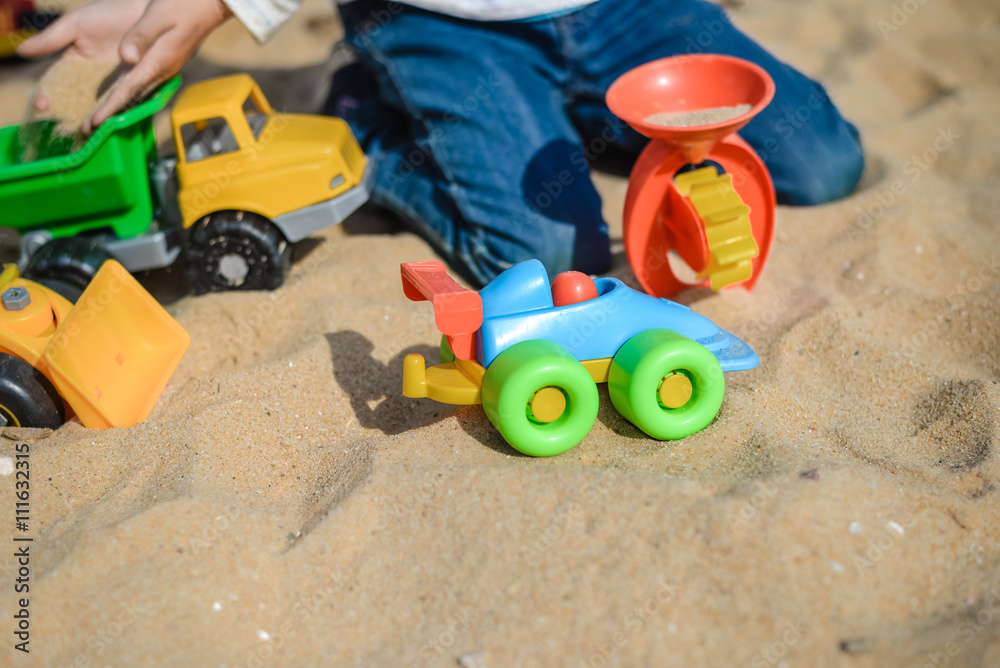 Kid having fun outdoors. Child playing toys on sunny summer day background Kid having fun outdoors. Child playing toys on sunny summer day background