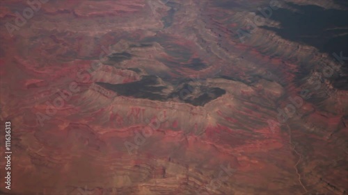 A red mountain range as seen through the window of an airplane. photo