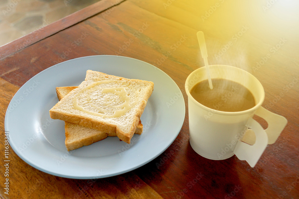 Hot coffee and bread toast topped with milk for breakfast and th