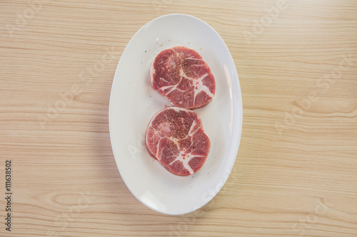 Fresh raw beef steak isolated on white plate