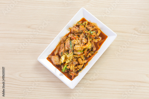 kimchi stir fried with pork meat in white plate