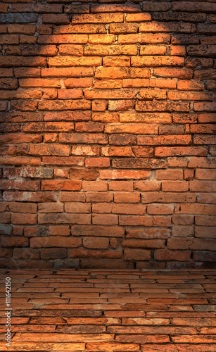 Low key photo of red brick wall with lighting effect. dark toned color of red brick wall. old and grunge brick wall. Brick wall for background