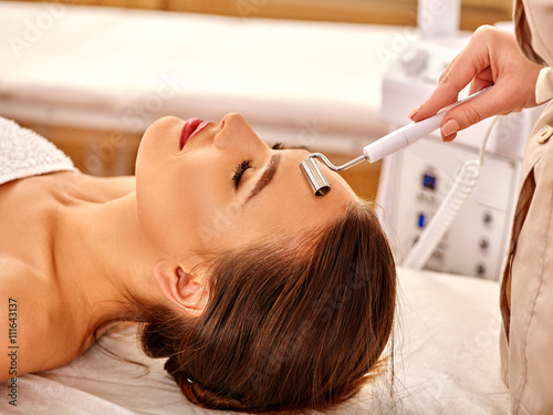 Tableau sur toile Young woman receiving electric galvanic face spa massage at beauty salon