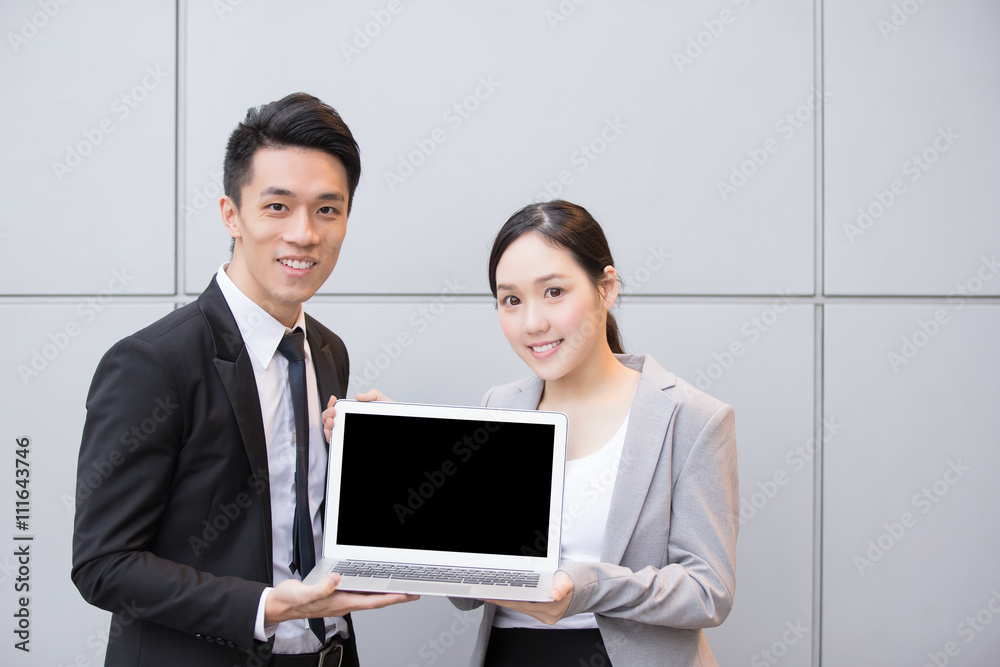 Business people show computer