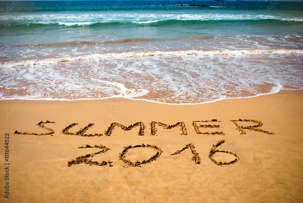 Fototapeta premium Inscription on wet sand Summer 2016. Concept photo of summer vacation.