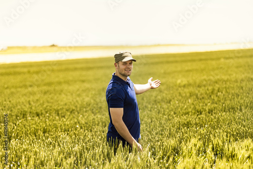 Fotografia Young farmer on field of wheat