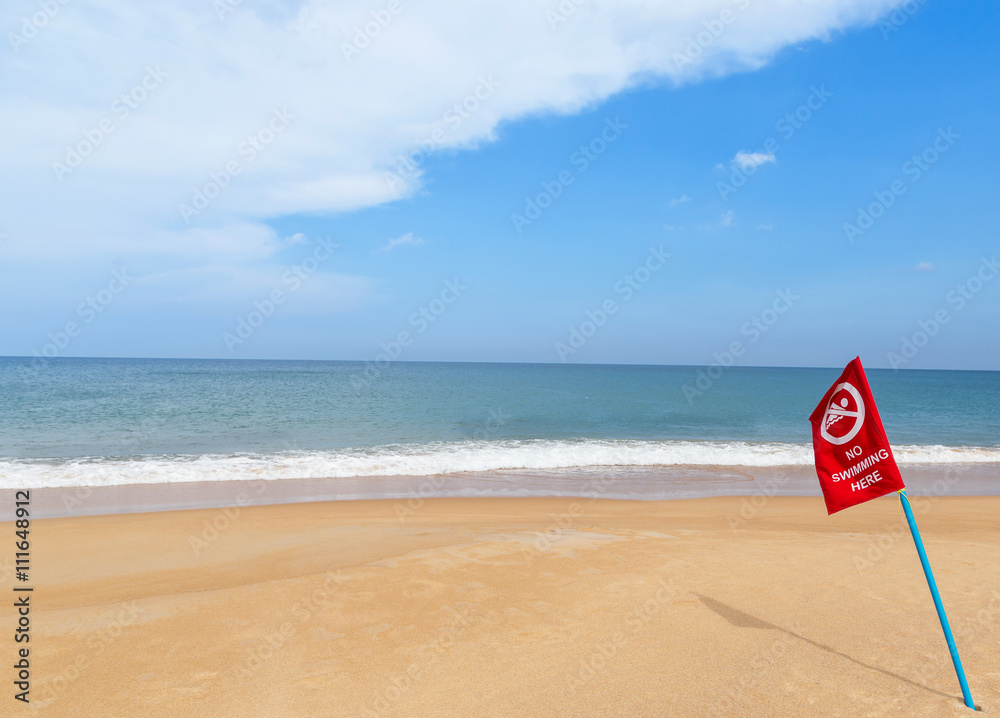 warning red flag no swimming sign on the beach warning red flag no swimming sign on the beach