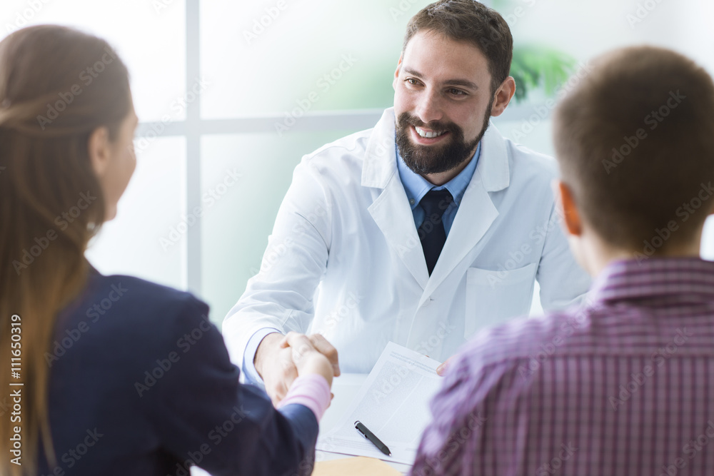 Couple signing a document at doctor's office Couple signing a document at doctor's office