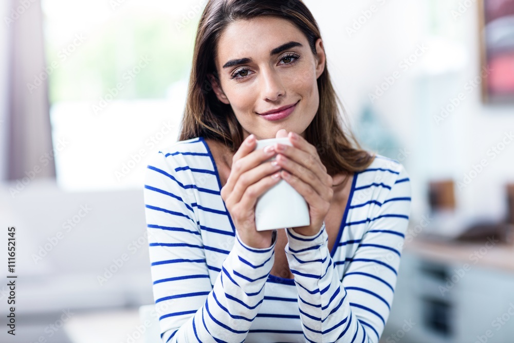 Portrait of beautiful young woman holding mug at home Portrait of beautiful young woman holding mug at home