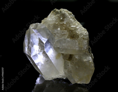 Shining rock crystal with reflections on black background