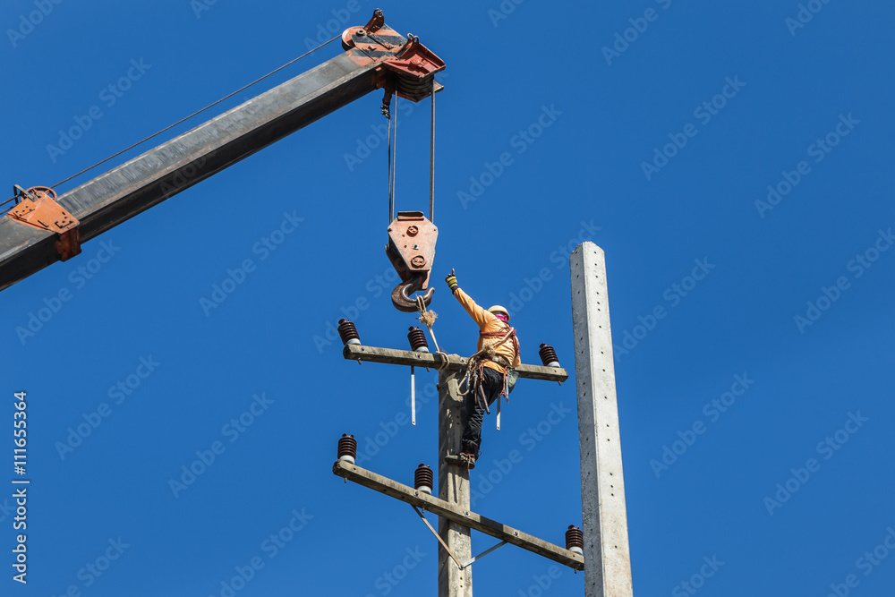 electrician repairing wire of the power line on electric power pole with crane electrician repairing wire of the power line on electric power pole with crane