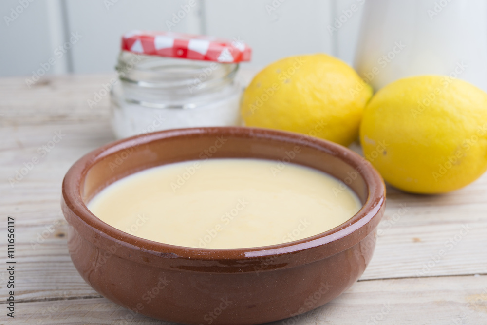 Traditional creme brulee on ceramic dish on wooden table Traditional creme brulee on ceramic dish on wooden table