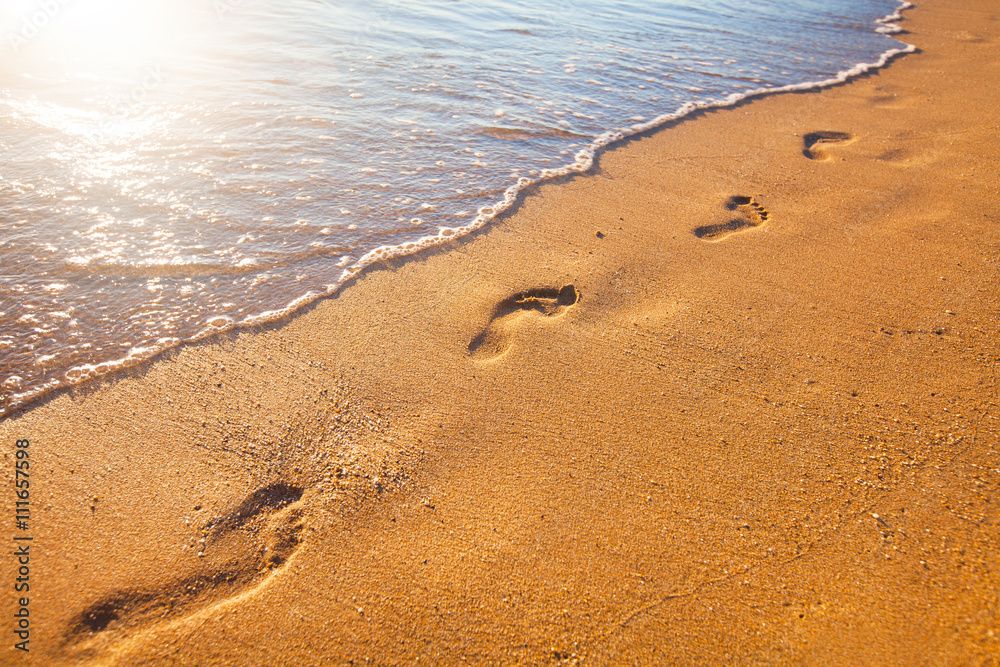 beach, wave and footprints at sunset time beach, wave and footprints at sunset time